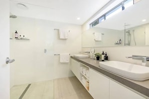 A modern bathroom with two sinks, a large mirror, and a shower. - Hamptons Style Beach Retreat in Noosa s Heart (Noosa)