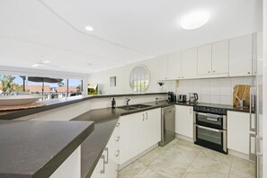 Enjoy cooking in this well-equipped kitchen with an oven and coffee maker.