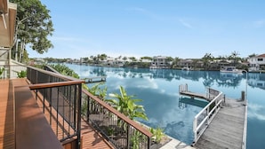 A waterfront property with a wooden deck, a dock, and a clear view of the water. - Seahorse Family & Pooch Friendly Waterfront Home (Noosa)