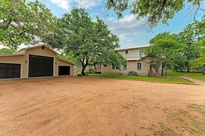 A two-story house with a garage and a covered porch.