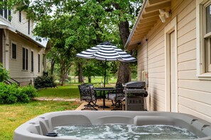 A backyard with a hot tub, patio furniture, and a grill. - Segner Hause | Firepit | 4 miles to Main (Fredericksburg)