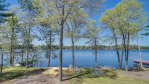 A lakeside campsite with trees, a dock, and a covered picnic area. - Spacious Lakefront New Auburn Home w/ Sunroom (New Auburn)