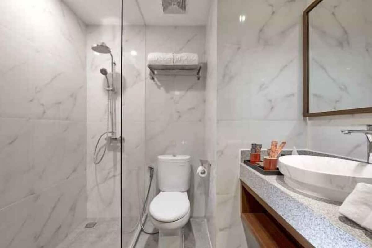Bathroom | Shower, rainfall showerhead, hair dryer, towels