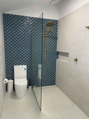 Shower, hair dryer, soap, toilet paper