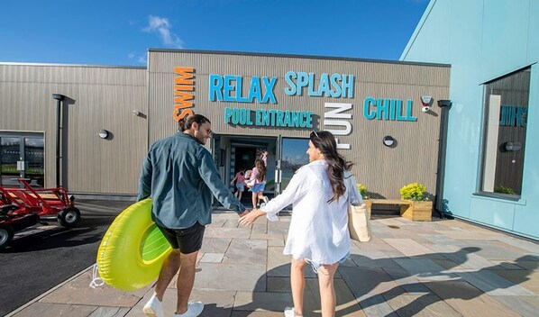 A building with a sign reading "Relax Splash Pool Entrance" and "Chill Zone".