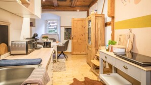 A compact kitchen with a toaster, microwave, and wooden cabinets. - Apartment 'Lemkamp Klein' with Wi-Fi (Markdorf)