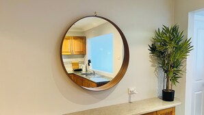 A kitchen with wooden cabinets, a countertop, a sink, and a potted plant. - Ocean-View Retreat for Family Getaways
 (Cringila)