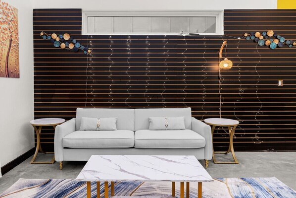 Relax in a stylish living room with a sofa, coffee table, and patterned rug.