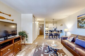 Relax in this stylish living space with a flat-screen TV, comfortable sofa, and dining area.