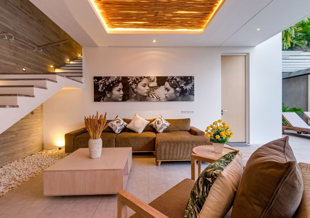 A modern living room with a sofa, coffee table, and a painting on the wall.