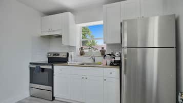 Comfort Apartment | Private kitchen | Full-size fridge, microwave, stovetop, electric kettle