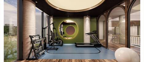 Un gimnasio moderno con equipo de ejercicio, cinta de correr y un amplio ventanal con vistas al exterior.