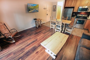 A kitchen with wooden cabinets, a stainless steel refrigerator, and an oven. - Fawn Valley Inn: 298 1 Bedroom Condo (Estes Park)