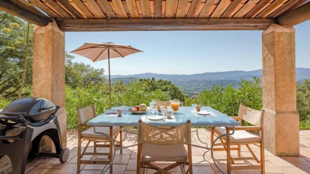 An outdoor dining area with a table, chairs, and a grill. - Le Clos d´Estelle by Interhome (La Garde Freinet)