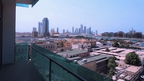 A high-rise building with a view of a city skyline, including several tall buildings and a body of water. - CITY POINT HOTEL (Manama)