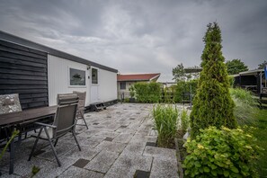 Relax outdoors in a serene setting with a patio area featuring a table and chairs.