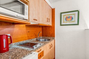 Fridge, microwave, stovetop, coffee/tea maker
