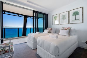 A hotel room with two beds, a large window with a view of the ocean, and framed botanical prints on the wall. - Jewel Stunning Ocean Views 2 Bed Apartment (Surfers Paradise)