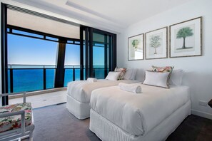 A hotel room with two beds, a view of the sea, and three framed botanical prints on the wall. - Jewel Stunning Ocean Views 2 Bed Apartment (Surfers Paradise)