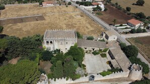 An aerial view of a historic building with a courtyard, surrounded by greenery and a stone wall. - Torre Rodosta  (Modica)