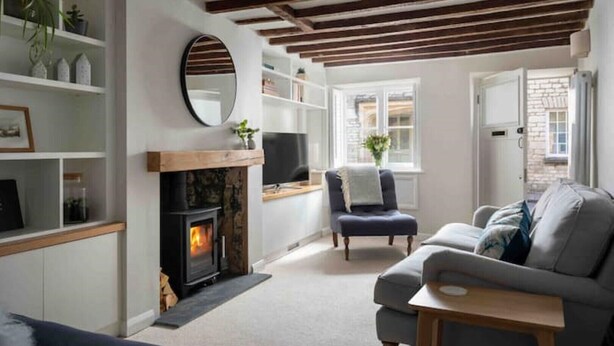 A cozy living room with a fireplace, a comfortable sofa, and a television.