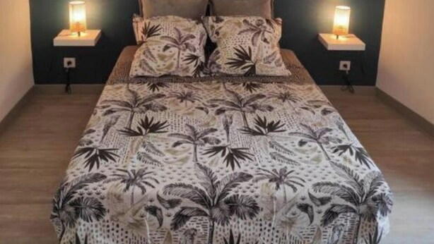 A bedroom with a bed, two bedside lamps, and a hanging light fixture. - Village house with exterior (Lambesc)