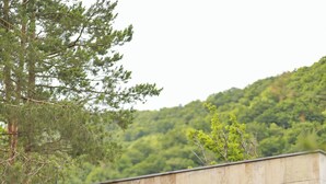 A modern two-story house with a stone facade, large windows, and a balcony. - Epoca (Tsaghkadzor)