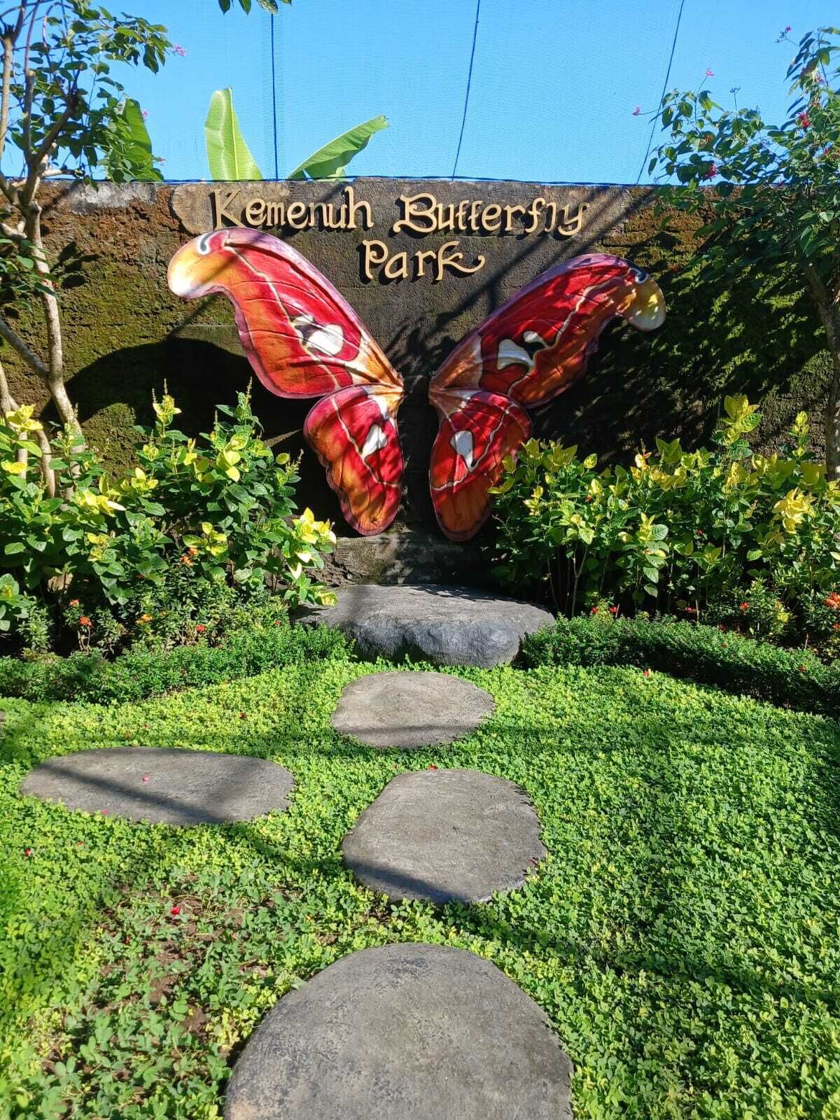 A garden pathway leading to a butterfly sculpture at Kemenah Butterfly Park.
