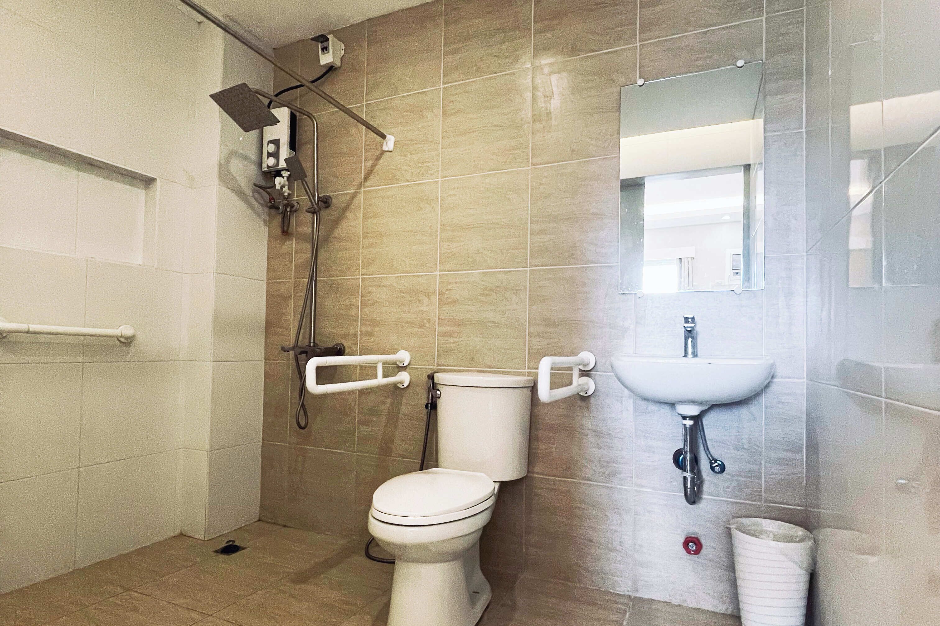 A bathroom with a toilet, a sink, and a shower.