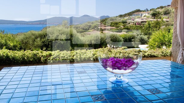 A table with a clear view of a coastal landscape, including a body of water and distant hills. - Villa in Porto Rotondo with 7 bedrooms sleeps 14 (Porto Rotondo)