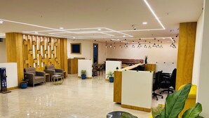 A modern office space with a reception area, seating, and workstations. - Hotel Plaza Airport Zone (Hyderabad)