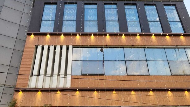 A hotel with a modern facade, large windows, and a sign indicating it is a hotel. - Hotel Plaza Airport Zone (Hyderabad)