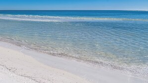 A beach with clear blue water and white sand. - NEW RENTAL - Updated Beach Front - Seawind 703 - Signature Properties (Gulf Shores)
