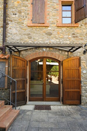 A stone building with a wooden door and a small window.