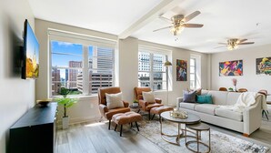 Signature Condo, 4 Bedrooms | Living room | 65-inch Smart TV with digital channels, table football -  Upscale Condos and Penthouses Close to Canal & Bourbon St. (New Orleans)
