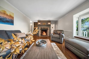 A living room with a fireplace, a sofa, a chair, and a coffee table.