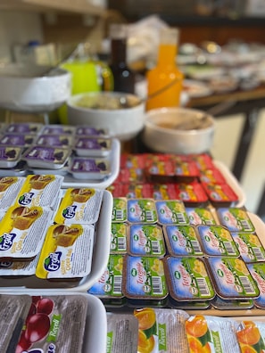 A variety of packaged food items, including honey and fruit preserves, displayed on a table. - Lütfü Bey Konağı (Gaziantep)