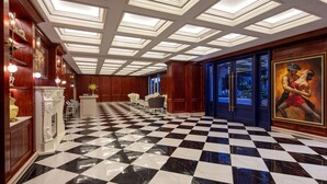 A hotel lobby with a checkered floor, a fireplace, and a large painting on the wall. - Tryp By Wyndham New Taipei Linkou (New Taipei City)