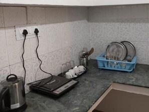 Fridge, electric kettle, cookware/dishes/utensils, dining tables