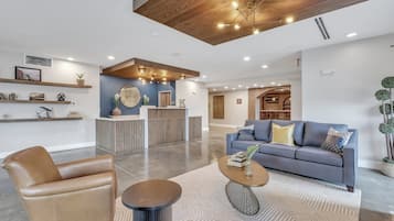 Experience the hotel's inviting lobby, featuring a comfortable seating area and polished concrete floor.