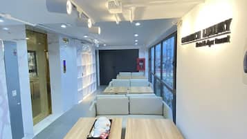 Mini-fridge, cleaning supplies, paper towels, dining tables