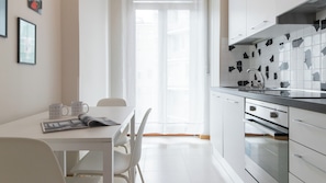 Comfort Apartment | Private kitchen | Fridge, stovetop, cookware/dishes/utensils, dining tables