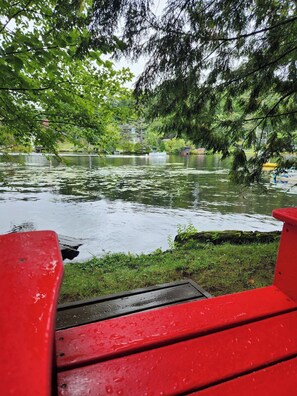 A park with a pond, benches, and trees. - A Private Romantic Waterfront Cabin with hot tub for two (Saranac Lake)