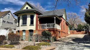 A two-story house with a porch and a small garden. - The 1900 House - 1 Block From DT (Prescott)