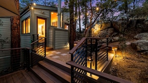 A cabin with a wooden deck, a staircase, and a small porch area. - Prescott Treehouse. Luxe 4BR/3Ba Home. Sleeps 10 (Prescott)