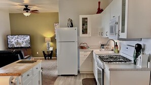 A modern kitchen with white cabinets, a refrigerator, a stove, and a microwave. - Comfy Mountain Side Stay - Incredible Views (Prescott)
