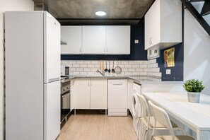Enjoy cooking in this well-equipped kitchen with oven, dishwasher, and sink.