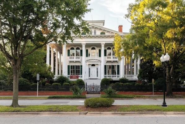 A historic building with a symmetrical facade, large windows, and a central entrance.