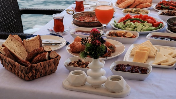 A table set with breakfast items and a view of the sea. - Black Lotus İzmir (Izmir)