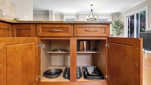 A kitchen with wooden cabinets, a countertop, and a built-in stove. - Pet-friendly, large yard, flexible extensions (Arlington)